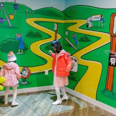 Two young girls playing in fun interactive pediatric dental office