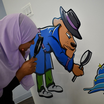 a dental staff member holding a magnifying glass 