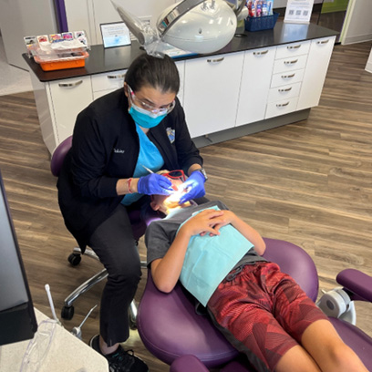 Dr. Vani Takiar examining a child’s teeth