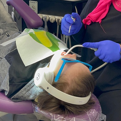 a child having their teeth cleaned by a dental hygienist