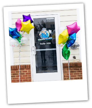 Front door of pediatric dental office with balloons