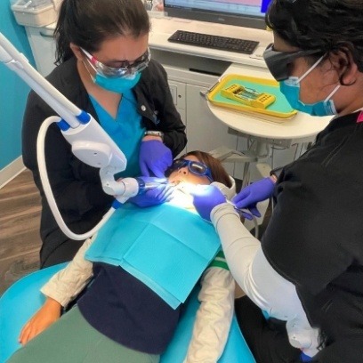 Doctor Takiar and pediatric dental team member treating a child