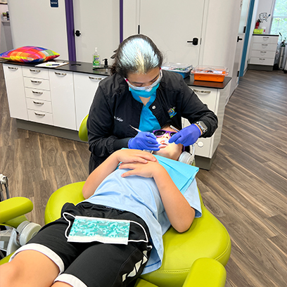 Agent T performing a dental exam in Leesburg on a child