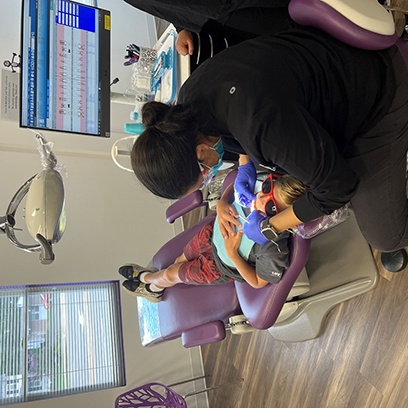 Dr. Vani Takiar treating a child’s teeth