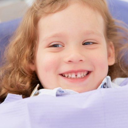 Young girl grinning in dental chair