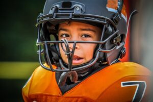 a child wearing a football uniform