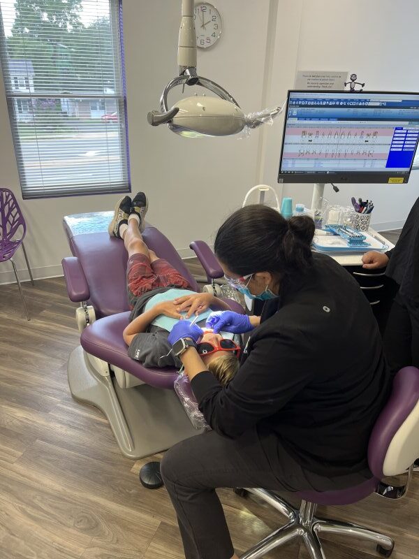 Dr. Vani Takiar examining a patient’s teeth