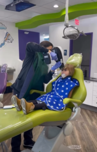 Dr. Vani Takiar taking an X-ray of a child's mouth